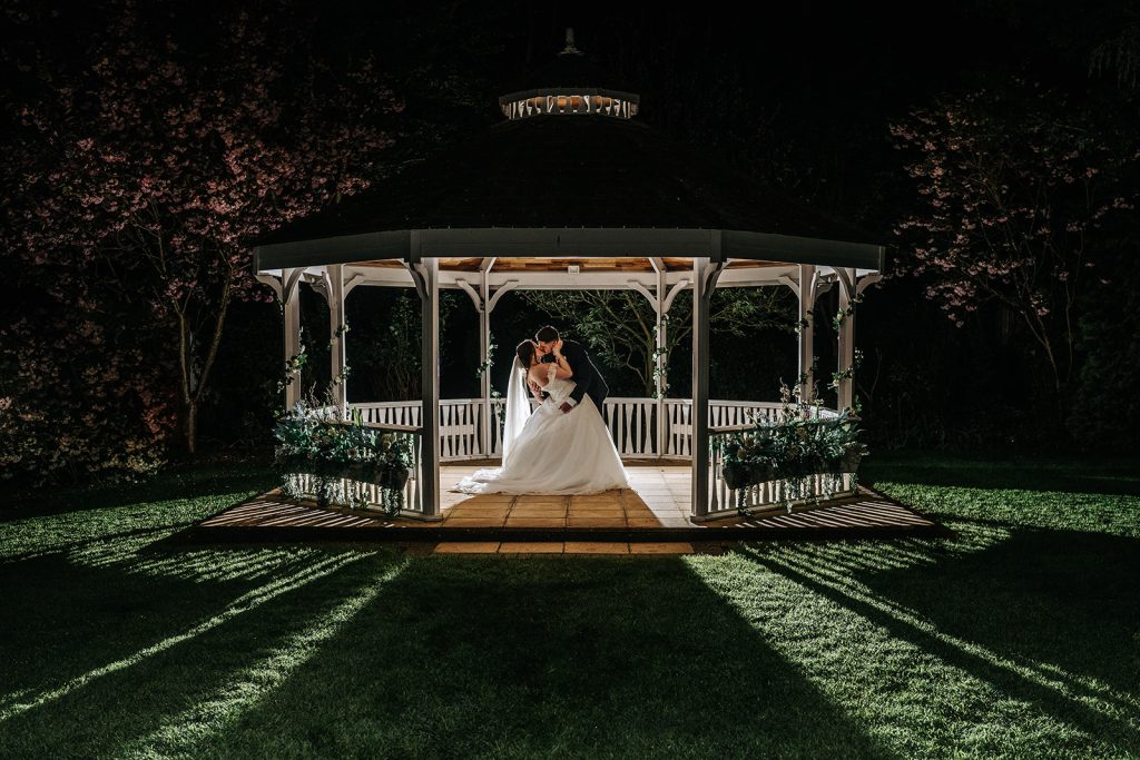 A romantic evening moment in the illuminated pavilion at The Stanwick Hotel.