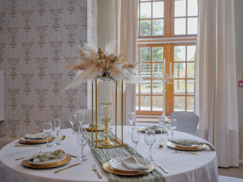 Elegant reception styling with pampas and gold accents at Hinwick Hall.